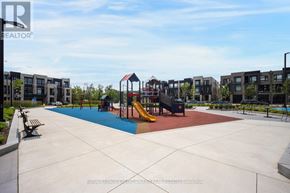 Vaughan (Steeles West Industrial) condo for rent - A playground with a slide and swings in a park.