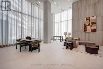 Vaughan (Steeles West Industrial) condo for rent - A spacious living room with a dining table and chairs.
