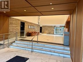 Toronto (Junction Area) condo for rent - A spacious lobby with a staircase and a couch.