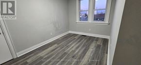 Oshawa (Vanier) apartment for rent - A room with a window and a wooden floor.