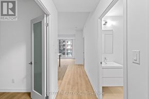 Markham (Unionville) condo for rent - A white hallway with a glass door leading to a bathroom.