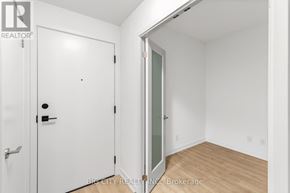 Markham (Unionville) condo for rent - A white door with a black handle and a glass window is in a room with wooden flooring.