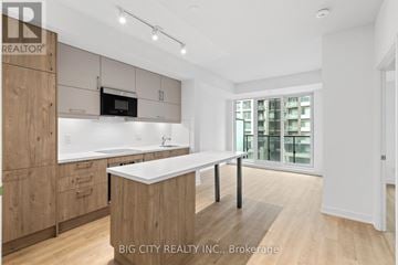 Markham (Unionville) condo for rent - A modern kitchen with wooden cabinets and a white countertop.