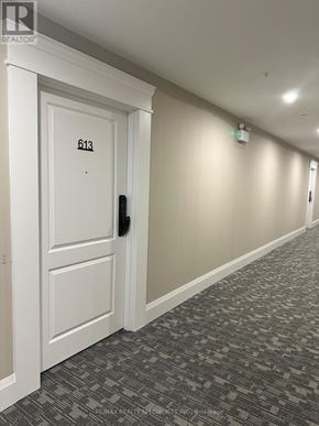 Milton (Co Coates) condo for rent - A hallway with a door numbered 613 and a black handle.