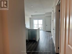 Milton (Co Coates) condo for rent - A hallway with a cabinet and a window in the distance.