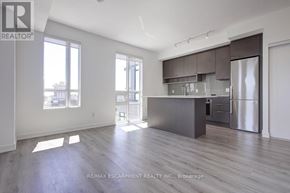 Oakville (Wm Westmount) condo for rent - A spacious kitchen with dark wood floors and modern appliances.