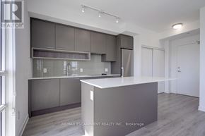 Oakville (Wm Westmount) condo for rent - A modern kitchen with dark grey cabinets and a white island.