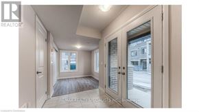 Brantford townhouse for rent - A white door with a glass window is open.