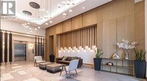 Mississauga (Creditview) condo for rent - A modern living room with a wooden panelled wall and a glass door.