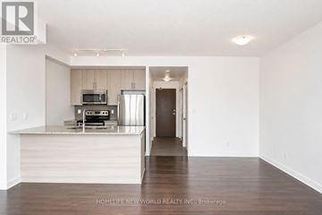 Mississauga (Creditview) condo for rent - A modern kitchen with white cabinets and a wooden island.