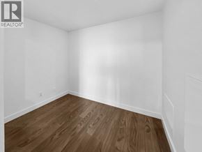 Vancouver apartment for rent - A room with wooden flooring and white walls.