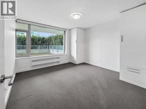 Vancouver apartment for rent - A room with a carpeted floor and a sliding glass door.