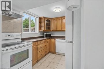 Hamilton apartment for rent - A kitchen with wooden cabinets and a white oven.