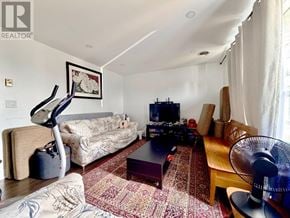 Niagara Falls (Dorchester) apartment for rent - A living room with a couch, a coffee table, and a fan.