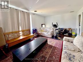 Niagara Falls (Dorchester) apartment for rent - A living room with a couch, coffee table, and a rug.