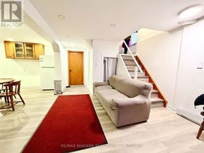 Niagara Falls (Dorchester) apartment for rent - A living room with a red carpet and a couch.