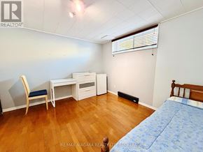 Niagara Falls (Dorchester) apartment for rent - A bedroom with a bed, desk, and chair.