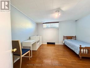 Niagara Falls (Dorchester) apartment for rent - A bedroom with a bed, desk, and chair.