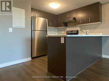 Guelph (Pineridge/Westminster Woods) condo for rent - A kitchen with a stainless steel refrigerator and a stove top oven.