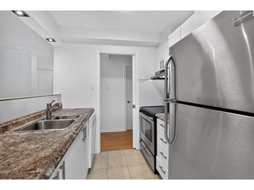 Gatineau (Hull) condo for rent - A kitchen with a granite countertop and stainless steel appliances.