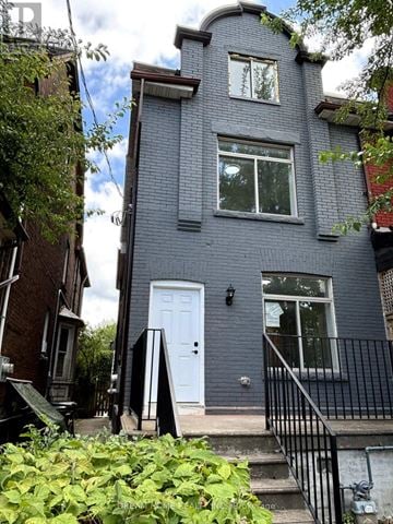 Toronto (University) apartment for rent - A grey house with a white door and windows.