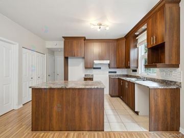 Gatineau (Aylmer) apartment for rent - A kitchen with wooden cabinets and a marble countertop.