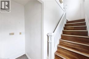 Oshawa apartment for rent - A staircase with wooden steps and white railings.