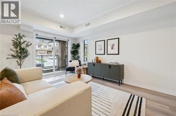Kitchener townhouse for rent - A living room with a white couch and a grey cabinet.