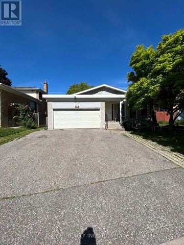 Toronto (Bayview Woods-Steeles) apartment for rent - A house with a white garage door is for sale.