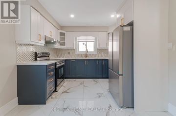 Toronto (Long Branch) apartment for rent - A kitchen with a marble floor and a refrigerator on the right.