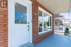 Toronto (Long Branch) apartment for rent - A white door with a glass window is on a brick wall.