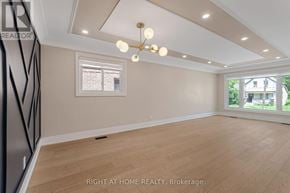 Toronto (Long Branch) apartment for rent - A well-lit room with a window and wooden flooring.