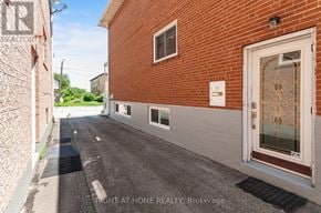 Toronto (Long Branch) apartment for rent - A red brick house with a white door and a window.