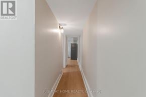 Toronto (Long Branch) apartment for rent - A long hallway with a door at the end.