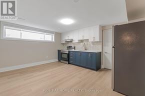 Toronto (Long Branch) apartment for rent - A kitchen with a refrigerator, cabinets, and a microwave.
