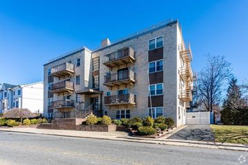 Ridgefield Park apartment for rent - A large apartment building with a balcony on the second floor.