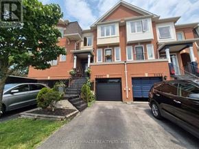 Burlington (Orchard) townhouse for rent - A two-story house with a red brick exterior and a garage.