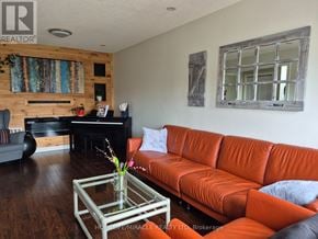 Burlington (Orchard) townhouse for rent - A living room with a red couch and a glass coffee table.