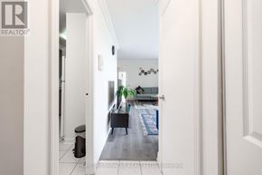 Mississauga (Applewood) condo for rent - A hallway with a white door and a black trash can.