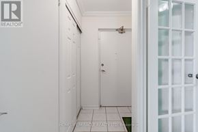 Mississauga (Applewood) condo for rent - A white door is in a hallway with a tiled floor.