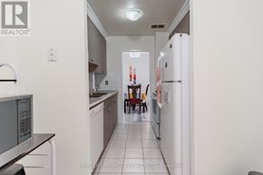 Mississauga (Applewood) condo for rent - A kitchen with white appliances and a white fridge.