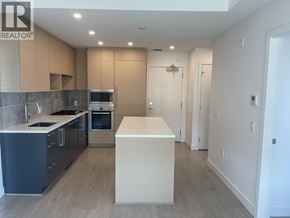 Vancouver apartment for rent - A modern kitchen with a large island in the middle.