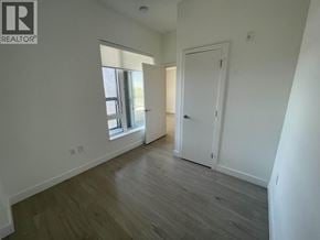 Vancouver apartment for rent - A room with a wooden floor and white walls, with a door on the right side.