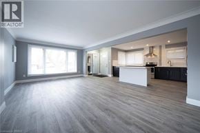Cambridge apartment for rent - A spacious, empty room with a kitchen area in the background.