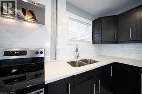 Cambridge apartment for rent - A modern kitchen with a stove, sink, and cabinets.