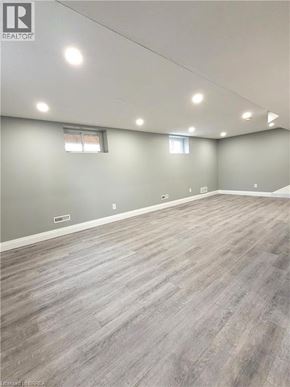 Cambridge apartment for rent - A spacious room with grey flooring and recessed lighting.