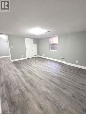 Cambridge apartment for rent - A room with grey walls and a wooden floor.