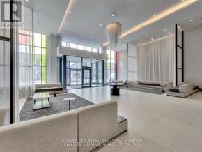 Markham (Commerce Valley) condo for rent - A spacious living room with a large window and a chandelier.
