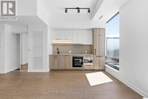 Toronto (Forest Hill South) condo for rent - A modern kitchen with a large island and a view of the outdoors.