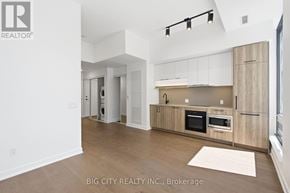 Toronto (Forest Hill South) condo for rent - A spacious kitchen with wooden cabinets and a white countertop.